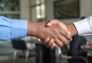 two men negotiating job offer by shaking hands